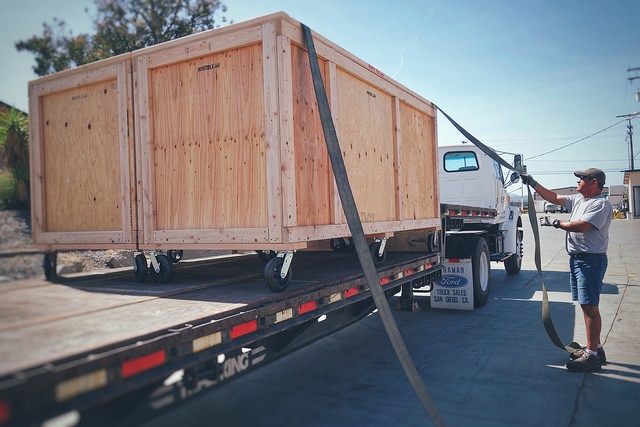crates-on-truck-getting-tied-down